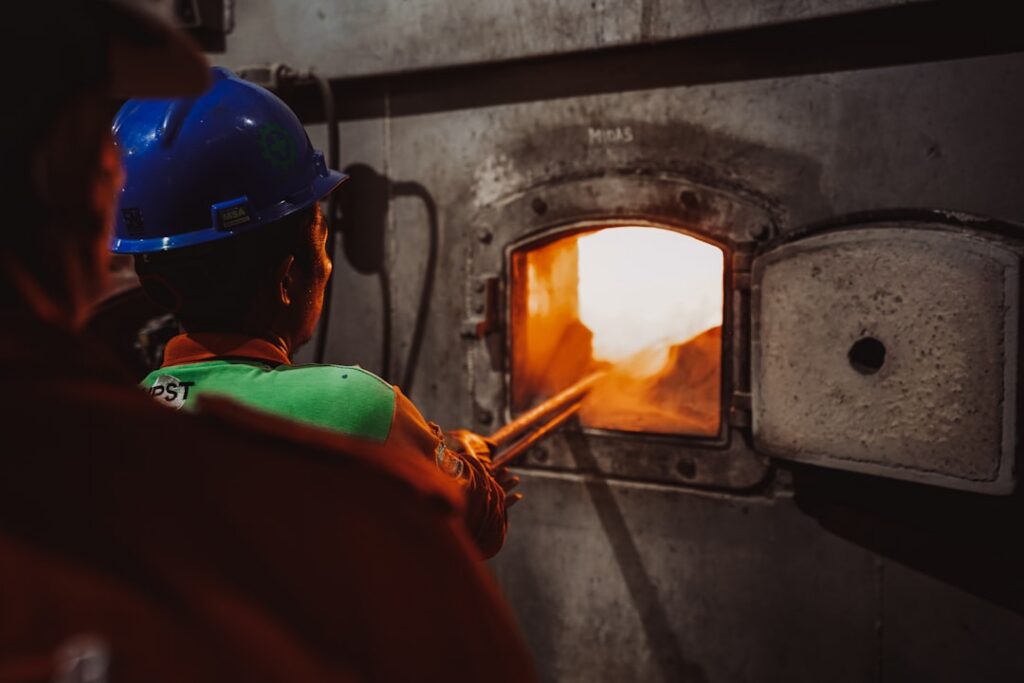 HVAC technician inspecting a furnace in a residential home - is an hvac maintenance plan worth it